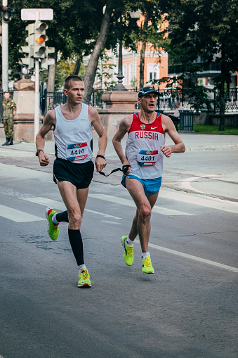 Ekaterinburg, Russia - August 01, 2015:  blind athletes run during Marathon From Europe To Asia, Ekaterinburg, Russia - August 01, 2015