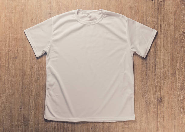 istock White blank t-shirt on dark wood desk 484964888