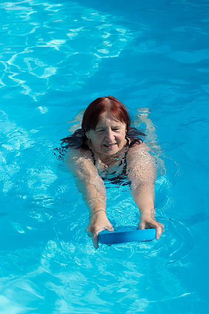 istock Senior active woman swimming 484965646