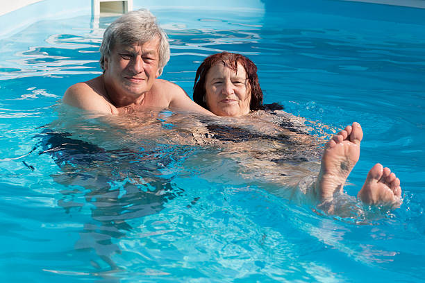 istock Happy senior couple in a swimming pool 484965994
