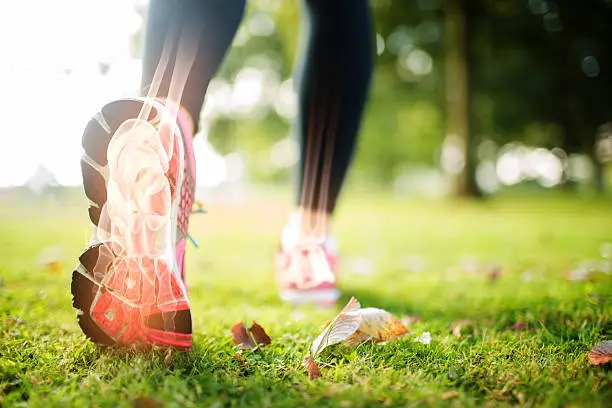 Photo of Highlighted foot bones of jogging woman