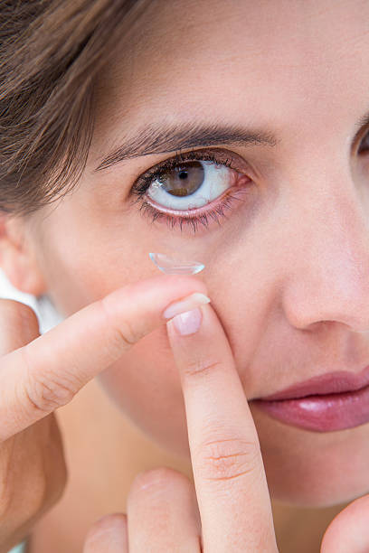 istock Pretty woman applying contact lens 484967560