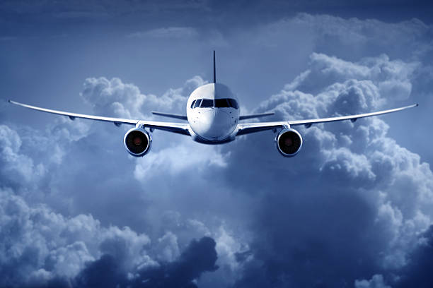 istock Passenger Airliner flying in the clouds 484969138