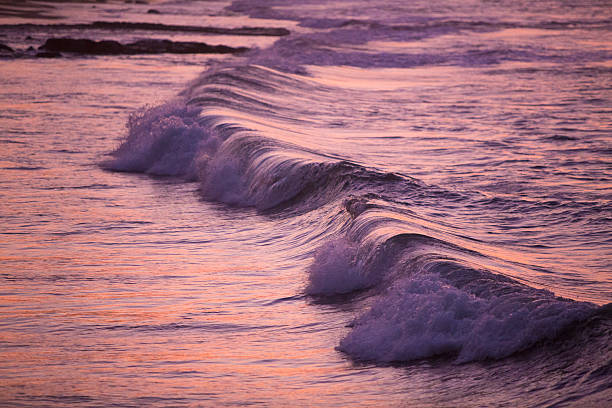 istock Pink purple waves during sunset in Mancora, Peru 484972304