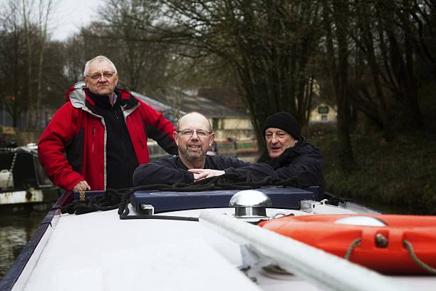 istock Three mature men on narrowboat 484972922