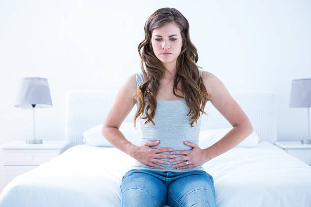 istock Pretty brunette suffering from stomach pain 484979792