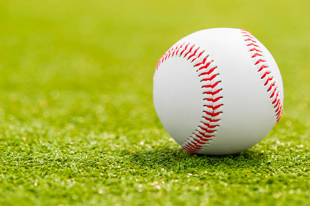 istock ball for playing baseball is on the green grass 484980992