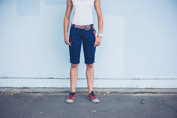 istock Stylish young woman by blue wall 484982316