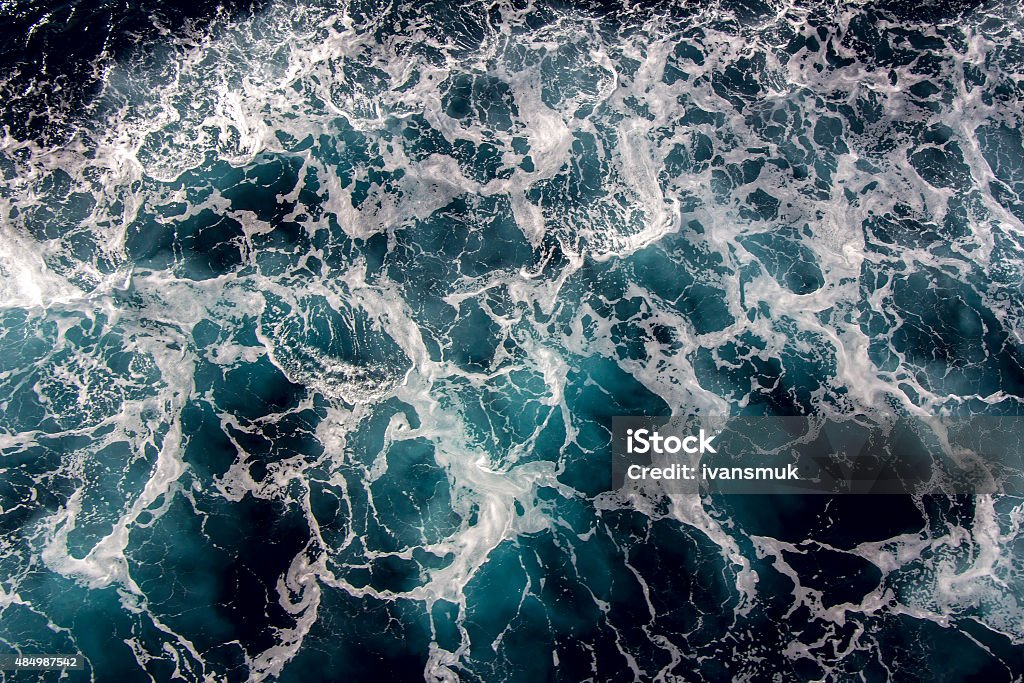 Seawater with sea foam Blue Seawater with sea foam as background 2015 Stock Photo