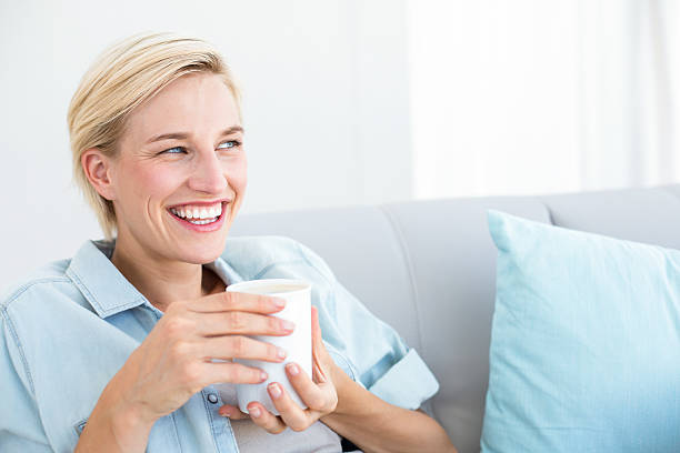 istock Pretty blonde woman relaxing on the couch 484987842