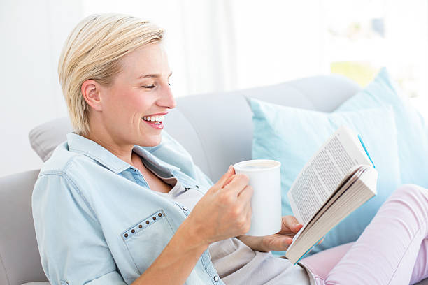 istock Pretty blonde woman reading a book 484987848