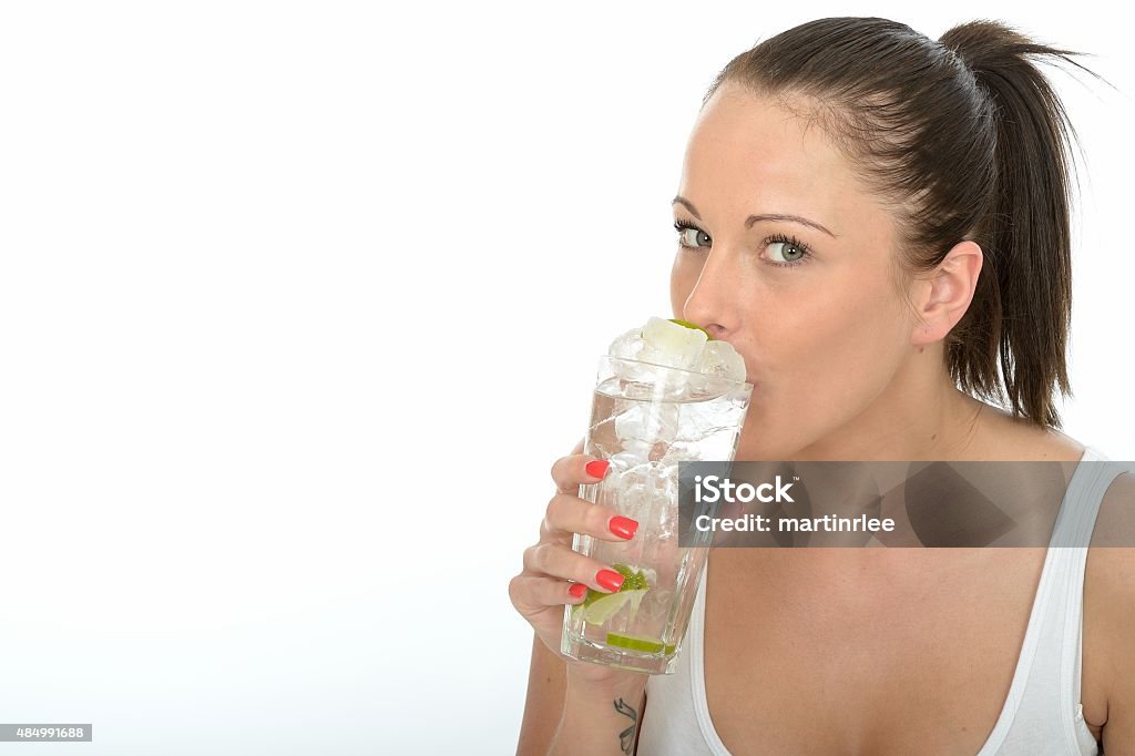 Young Woman Holding a Glass of Iced Water with Ice Healthy Happy Attractive Young Woman Holding a Glass of Iced Water with Lime Drinking Stock Photo