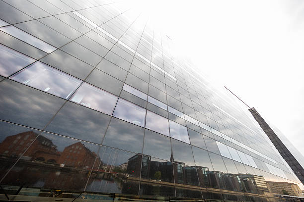 Den Sorte Diamant - Black Diamond - facade is made of black granite.Looking upwards the facade seem to melt into the sky, while reflecting Islands Brygge across Copenhagen inner harbour.