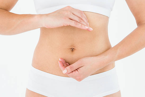 istock Fit woman with hands on her stomach 484997982