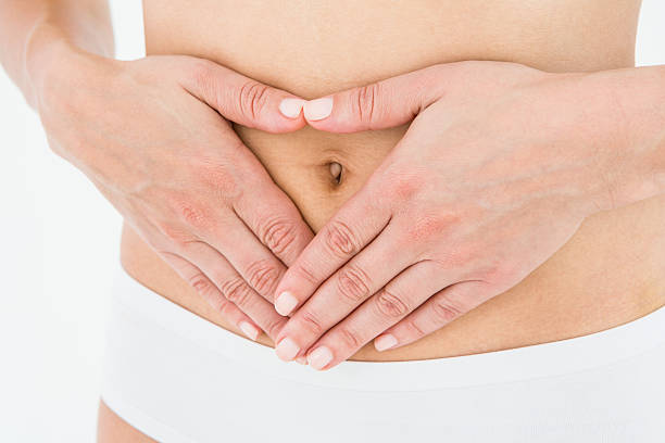 istock Fit woman with hands on her stomach 484997984