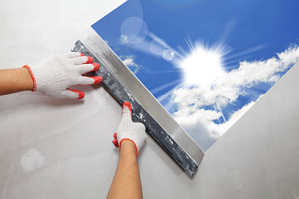 Contractor Plasterer.  Sun and sky stock photo