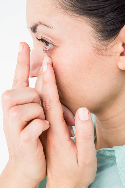 istock Brunette putting her contact lens 485006610