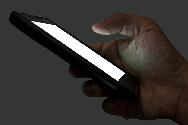 istock Right Hand Holding A Smartphone At Night On Gray Background 485011354