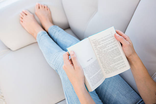 istock Woman reading on couch 485011712