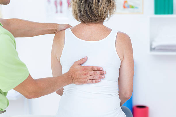 istock Doctor examining his patient back 485012808