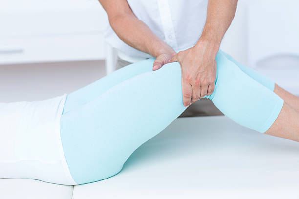 istock Physiotherapist doing leg massage to his patient 485013864