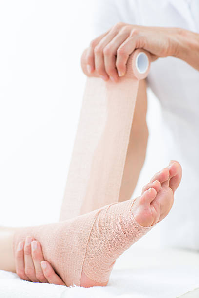 istock Doctor bandaging her patient ankle 485013906