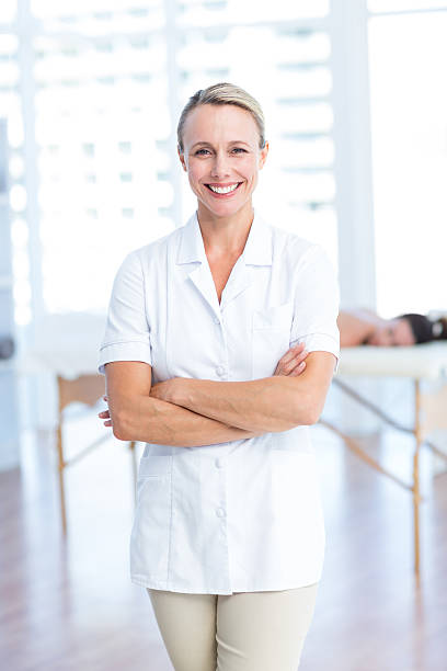 istock Physiotherapist smiling at camera arms crossed 485017166