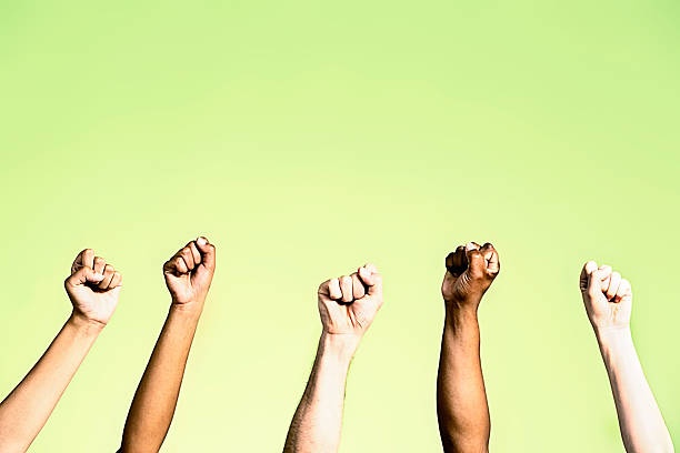 istock Power salute from group with clenched fists on green 485018405