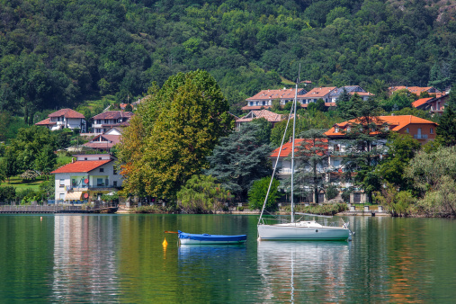 Yacht and small village on Lake Avigliana in Italy.