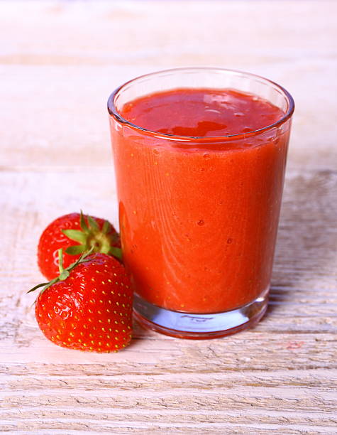 istock Strawberry smoothie in glass with two berries 485020415