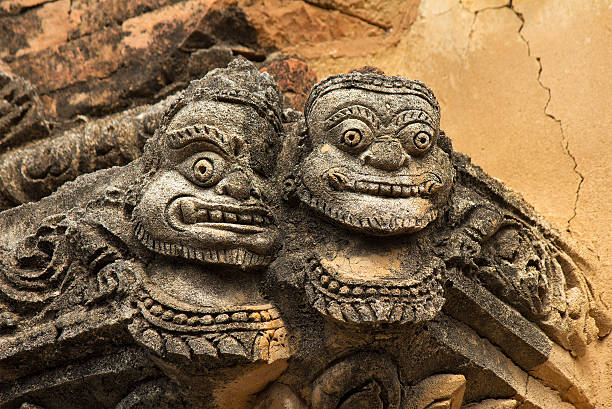 istock statue of two faces(full face) on the corner of ancient temple 485021725