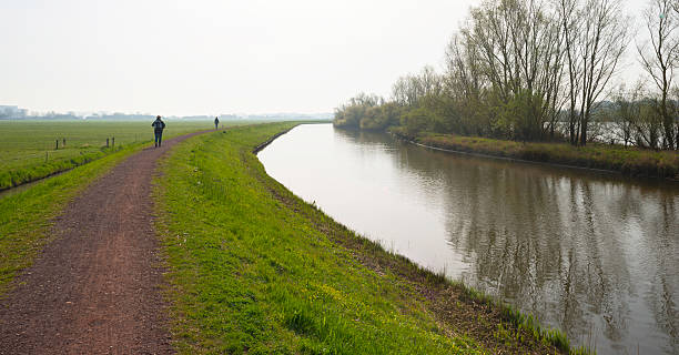 istock Woman hiking on a dike in spring 485021813