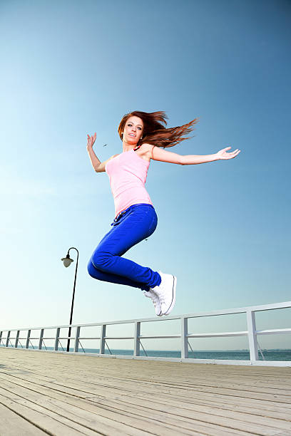 istock Attractive girl Young woman jumping sky 485022855