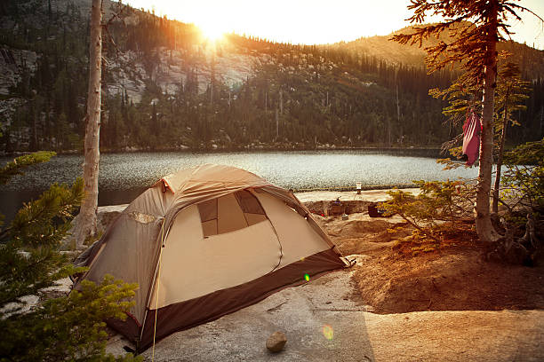 Backcountry camping along a beautiful alpine lake. stock photo