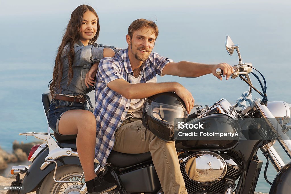 Biker man and girl Two people and bike - fashion woman and man. Adventure and vacations concept Beauty Stock Photo