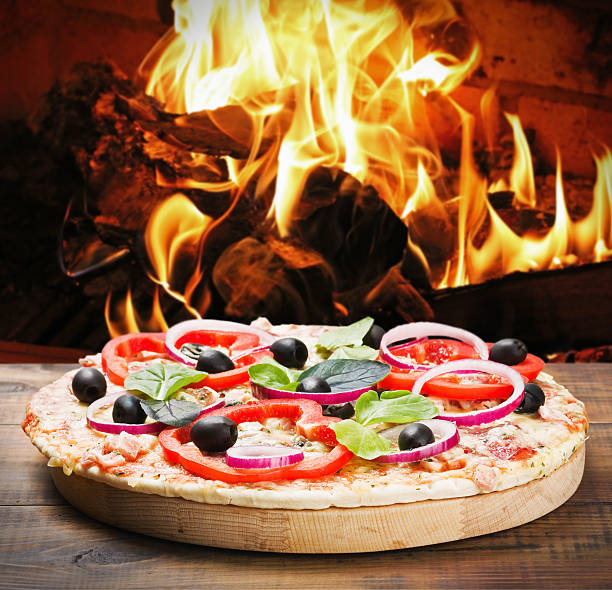 istock pizza with ham and cheese cooked on the fire 485024279