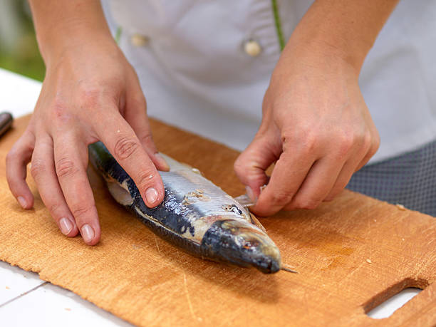 istock Cleaning herring cook on the kitchen wooden board 485024801