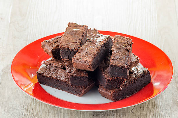 istock Pieces of chocolate cake served on red dish 485024827