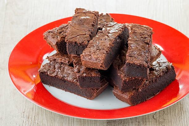 istock Pieces of chocolate cake served on red dish 485024843