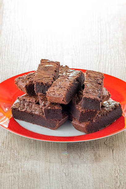 istock Pieces of chocolate cake served on red dish 485024859