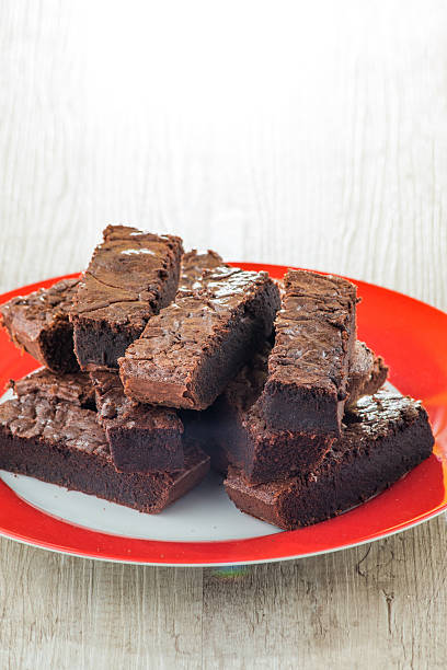 istock Pieces of chocolate cake served on red dish 485024863