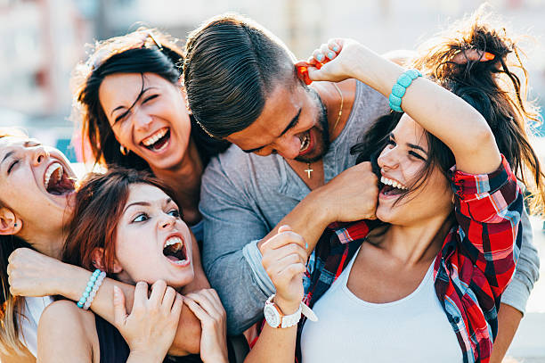 Roof party A group of friends having a party on the roof. woman strangles man stock pictures, royalty-free photos & images