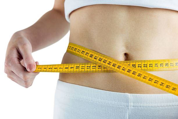 istock Slim woman measuring her waist 485030856