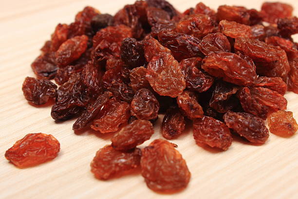 istock Brown raisins on wooden table, healthy eating 485035820