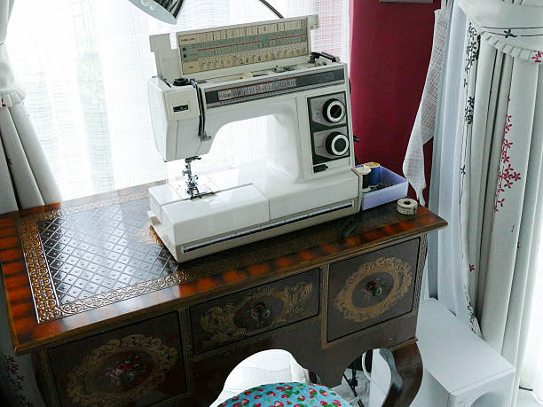 istock sewing machine on vintage wooden desk 485035896