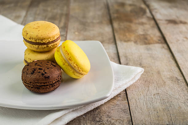 istock Different kinds of macaroons in stack on light wooden background 485036360