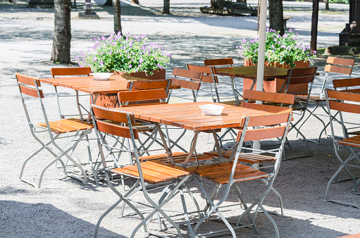 Folding tables and chairs made of wood in a beer garden.