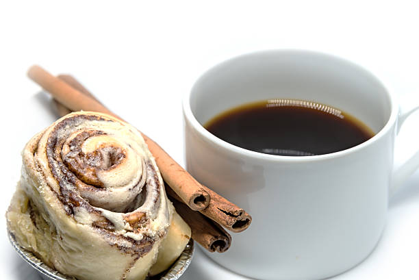 Cinnamon roll bun with coffee isolated