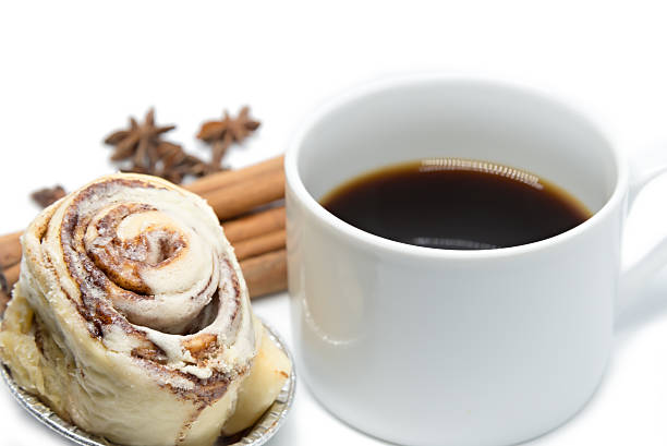 Cinnamon roll bun with coffee isolated