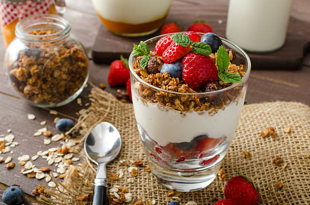 istock Yogurt with baked granola and berries in small glass 485041618